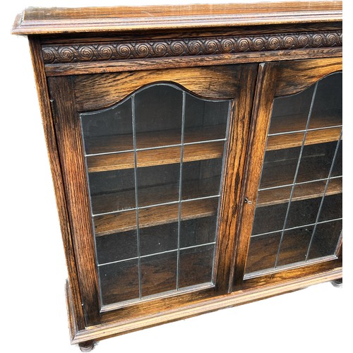 398 - Oak 2 door leaded glass book case measures approximately 38.5 inches tall 42.5 inches wide 11 inches... 