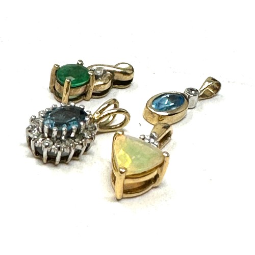 155 - 4 x 9ct  gold pendants inc. diamond, topaz, emerald & opal (2.8g)