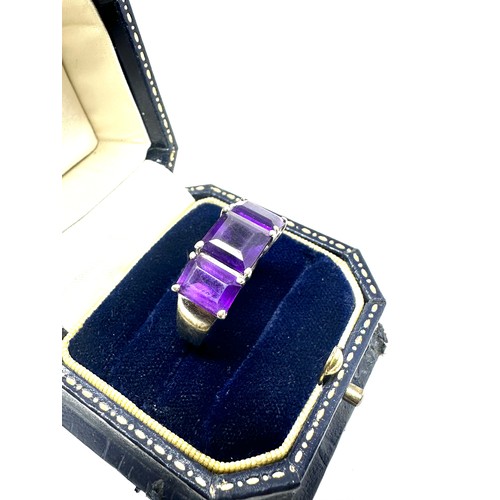 218 - 9ct gold amethyst three stone ring (4.2g)