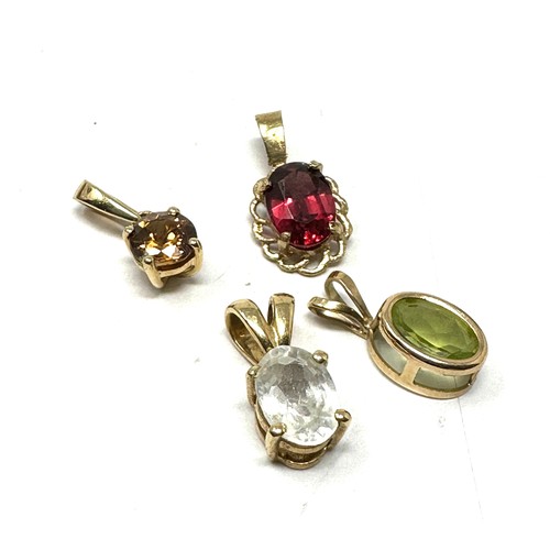 153 - 4 x 9ct gold gemstone pendants inc. garnet, peridot, and zircon (2.2g)