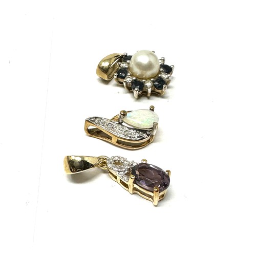 154 - 3 x 9ct gold gemstone pendants inc. diamond, opal, sapphire, and purple spinel (2.4g)