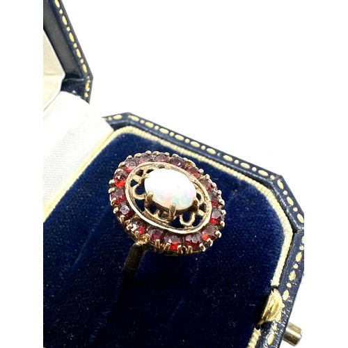 175 - 9ct gold opal & garnet halo ring (3.6g)