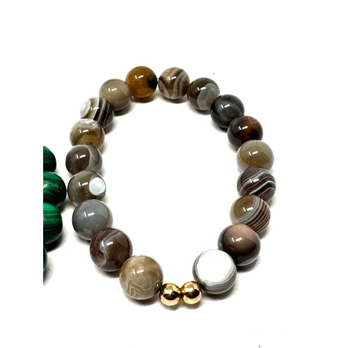 226 - 2 x 9ct gold beaded gemstone bracelets inc. malachite, banded agate (70g)