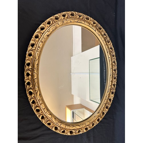 71 - Guilt framed oval mirror measures approx 23 inches wide by 19 inches long