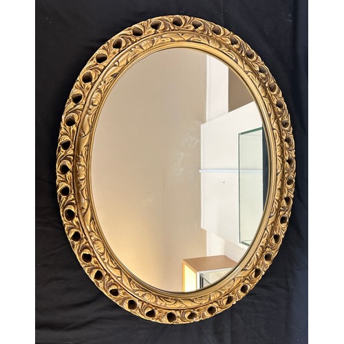 71 - Guilt framed oval mirror measures approx 23 inches wide by 19 inches long