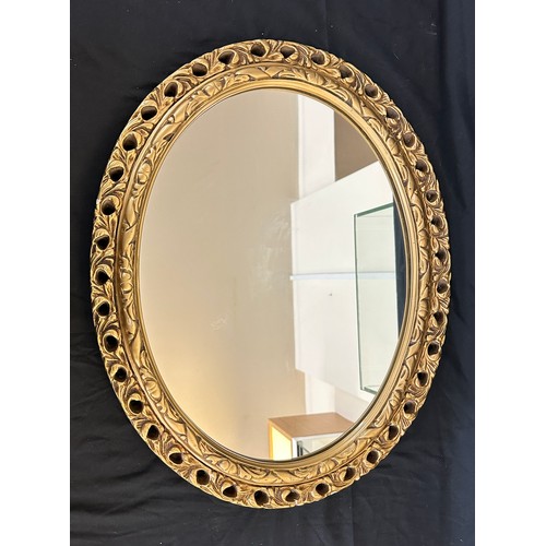 71 - Guilt framed oval mirror measures approx 23 inches wide by 19 inches long