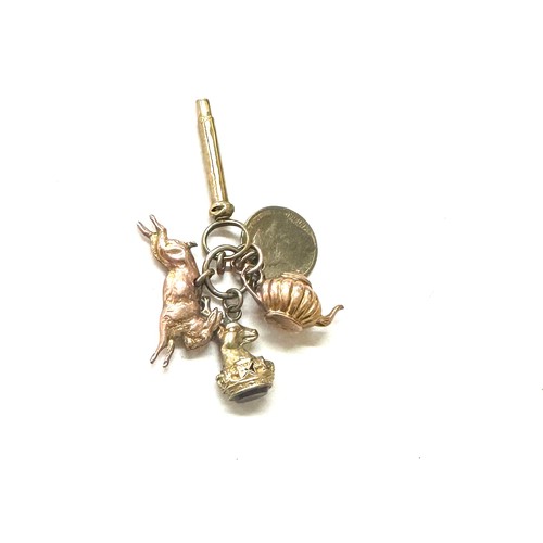 398 - Selection of gold/ gold coloured charms includes tea pot, rabbit and a deer