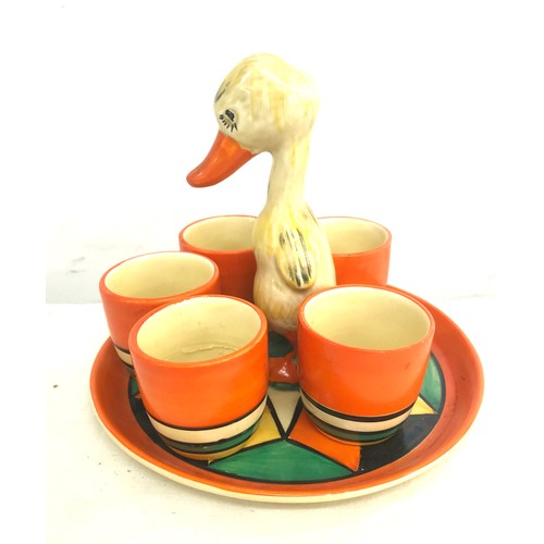 Clarice Cliff pottery egg cups and a chick tray, the chick has been damaged, re-glued and a chip to the base, please refer to images