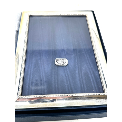 116 - 2 boxed silver picture frames largest measures approx 18cm by 13cm