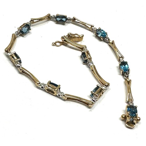 257 - 9ct gold blue topaz & diamond bracelet (4.4g)