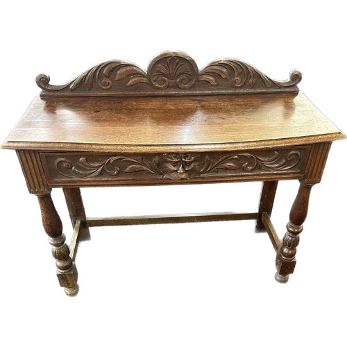 602 - Oak carved green man hall table with drawer, circa 1920's approximate measurements: Width 42 inches,... 