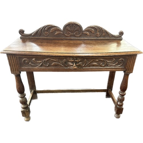 602 - Oak carved green man hall table with drawer, circa 1920's approximate measurements: Width 42 inches,... 