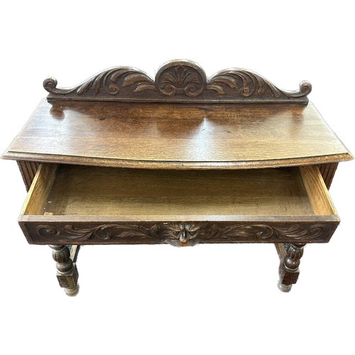 602 - Oak carved green man hall table with drawer, circa 1920's approximate measurements: Width 42 inches,... 