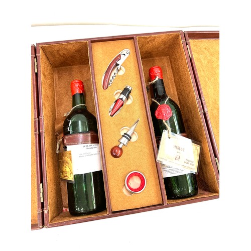 575 - Leather cased vintage Merlot wine set