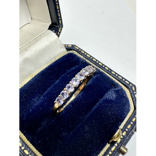 241 - 9ct gold tanzanite half eternity ring (1.4g)