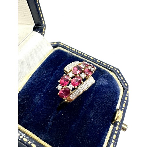 192 - 9ct gold diamond & ruby dress ring (2.6g)