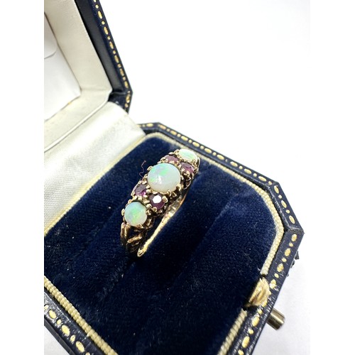 218 - 9ct gold opal & ruby seven stone ring (2g)