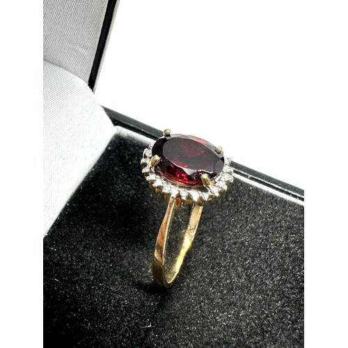 191 - 9ct gold diamond & garnet oval halo ring (2.1g)