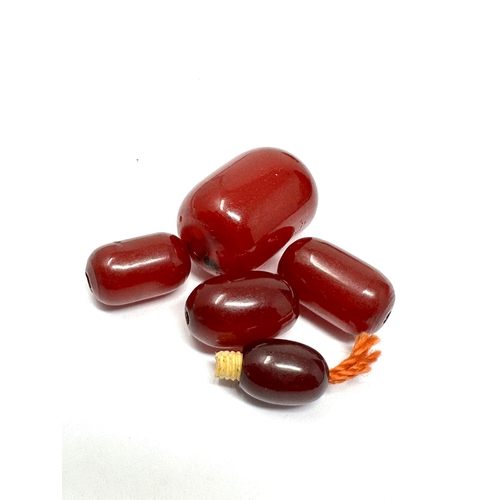 106 - Selection of loose cherry amber bakelite beads 7.6g good internal streaking