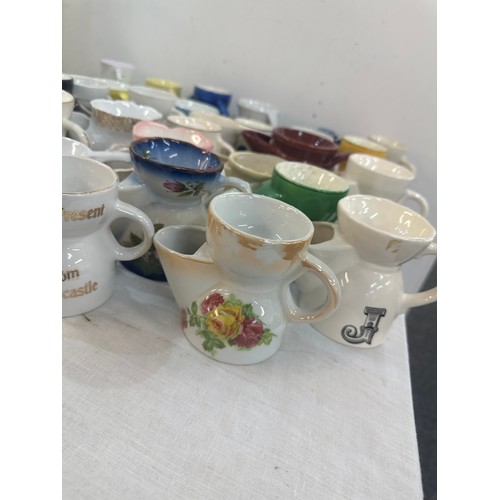 131 - A large collection of porcelain shaving mugs various makers and designs