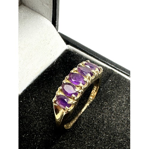 298 - 9ct gold amethyst oval cut five stone ring (2.9g)