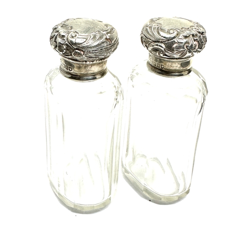 59 - Pair of antique silver top perfume bottles London silver hallmarks each measure approx height 9cm