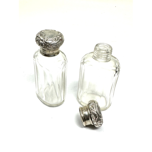 59 - Pair of antique silver top perfume bottles London silver hallmarks each measure approx height 9cm