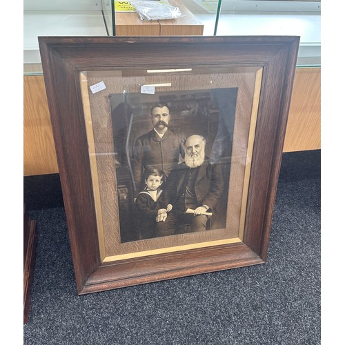 175 - Large vintage wooden framed family portrait measures approx 28 inches wide by 33 inches tall