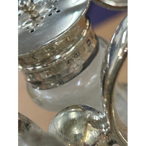 619 - Selection of silver and silver plated glass items to include a cruet set with silver rims, pair of a... 