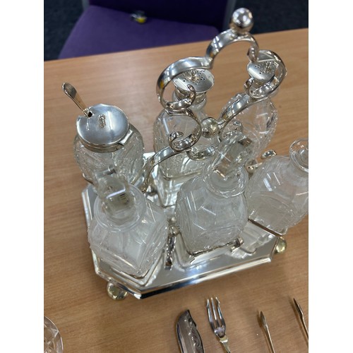 619 - Selection of silver and silver plated glass items to include a cruet set with silver rims, pair of a... 