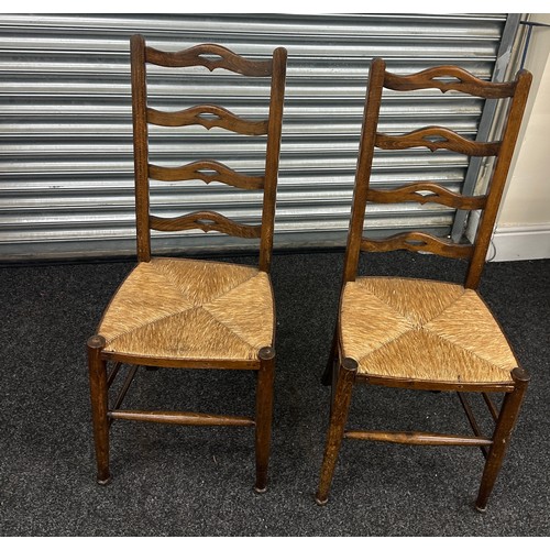 371 - A pair of ladder back chairs with straw sits