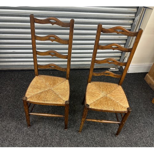 371 - A pair of ladder back chairs with straw sits