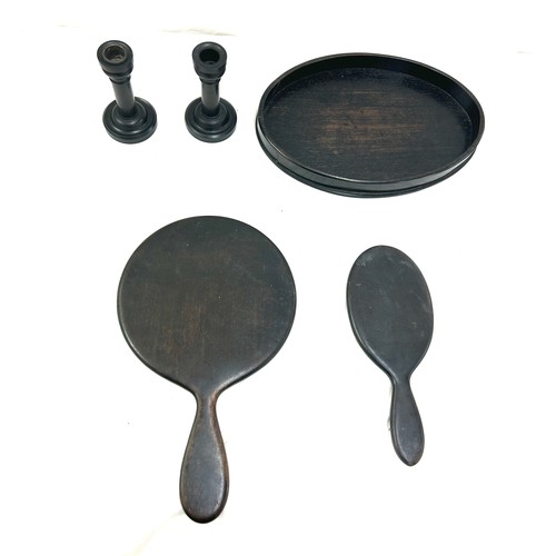 106 - Part Ebony dressing table set includes mirrors, candle sticks etc