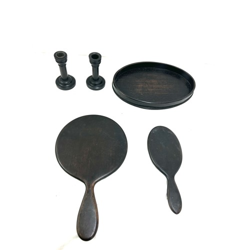 106 - Part Ebony dressing table set includes mirrors, candle sticks etc