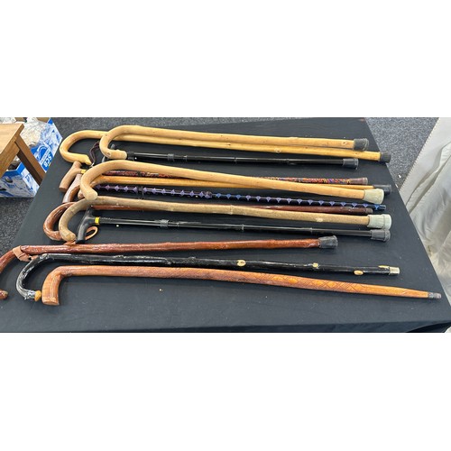 132 - Large selection of walking sticks in a pottery stick stand