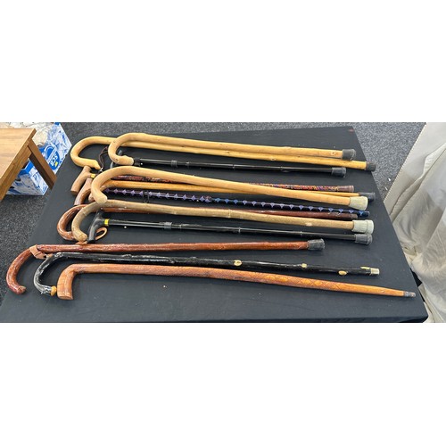 132 - Large selection of walking sticks in a pottery stick stand