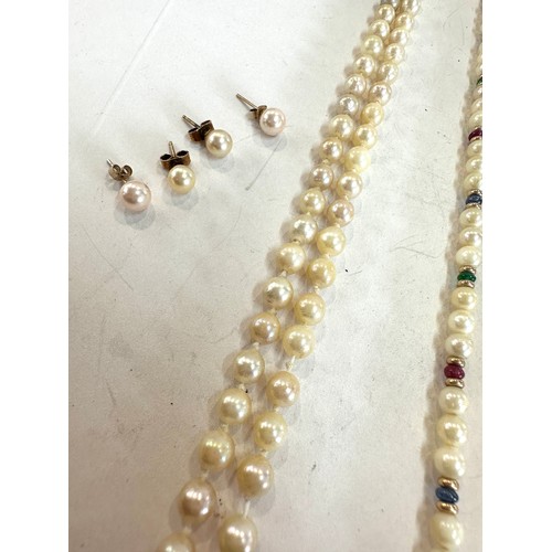 467 - 9ct gold cultured pearl necklace set with rubies, emeralds, sapphires and others