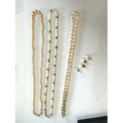 467 - 9ct gold cultured pearl necklace set with rubies, emeralds, sapphires and others