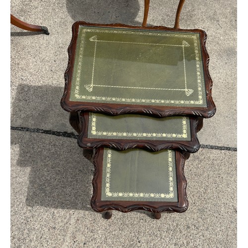 379 - Mahogany nest of three tables with glass top measures approx 20 inches wide by 21 inches tall