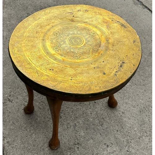 377 - Brass topped oak legged occassional table measures approx 20 inches diameter and 19 inches tall