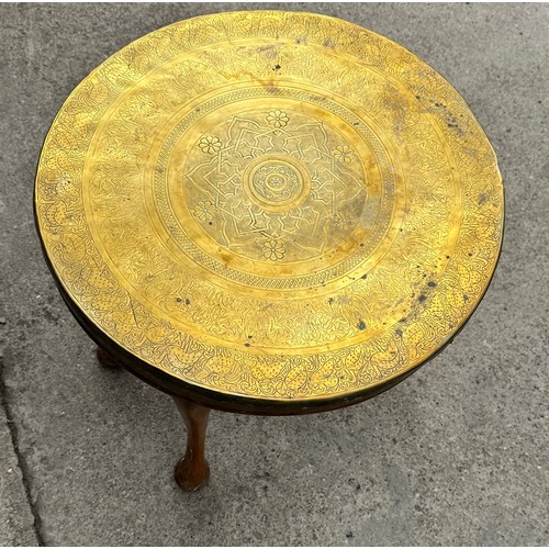 377 - Brass topped oak legged occassional table measures approx 20 inches diameter and 19 inches tall