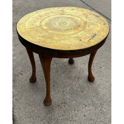 377 - Brass topped oak legged occassional table measures approx 20 inches diameter and 19 inches tall