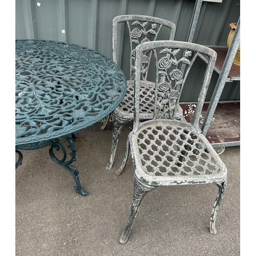 100P - Cast aliminium table and 2 chairs table measures 28 inches tall 39 inches diameter