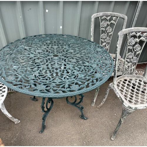 100P - Cast aliminium table and 2 chairs table measures 28 inches tall 39 inches diameter