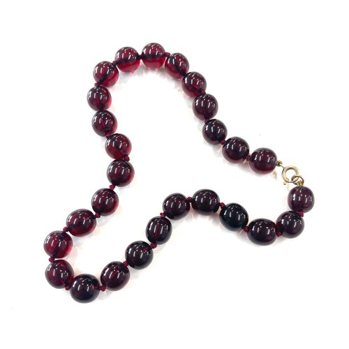 500 - Cherry amber bakelite beads with a gold coloured clasp