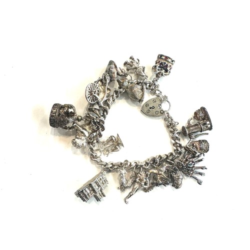 514 - Ladies silver charm bracelet and charms, total weight 80grams