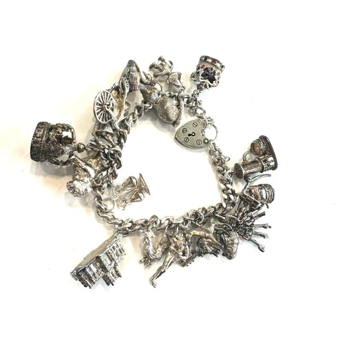 514 - Ladies silver charm bracelet and charms, total weight 80grams