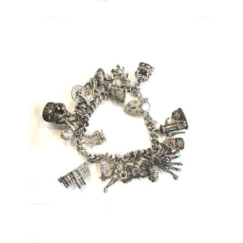 514 - Ladies silver charm bracelet and charms, total weight 80grams