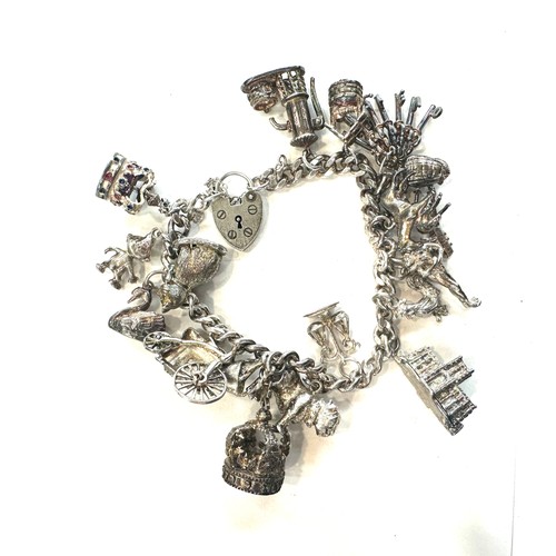 514 - Ladies silver charm bracelet and charms, total weight 80grams