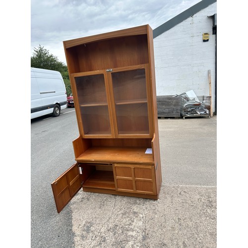 411 - Teak Nathan 2 door bookcase measures approximately 76 inches tall 40 inches wide 18 inches depth